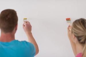 couple painting interior wall photo