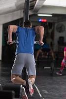 man doing exercises parallel bars photo