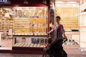 mother with  little girl in a stroller in front of  jewelry shop photo