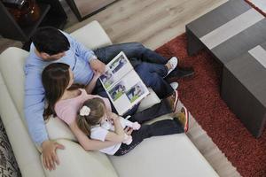 happy family looking photos at home