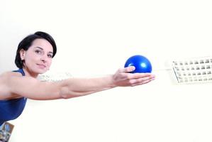 .happy young woman exercising in a gym photo