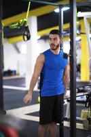 man doing pull ups on the vertical bar photo