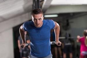 man doing exercises parallel bars photo