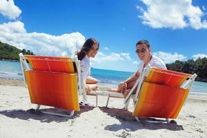 happy couple have fun on the beach photo