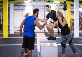 athletes working out  jumping on fit box photo