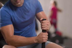 young man after workout with hammer and tractor tire photo