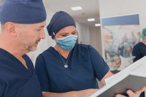 orthopedic doctor working together with his multiethnic team photo