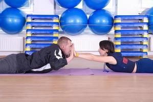 .feliz pareja en el gimnasio haciendo ejercicio foto