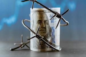 Dollar banknote with barbed wire, Economic crisis, background effect with little noise photo