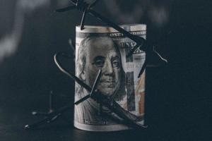 Dollar banknote with barbed wire, Economic crisis, background effect with little noise photo