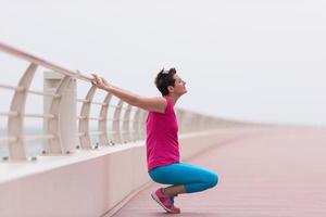 woman stretching and warming up on the promenade photo