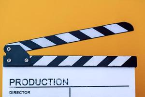 movie clapper isolated on yellow background photo