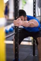 man doing pull ups on the vertical bar photo