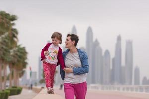 mother and cute little girl on the promenade photo