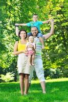 happy young couple with their children have fun at park photo