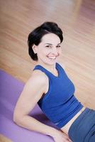 young and healthy woman in fitness club photo