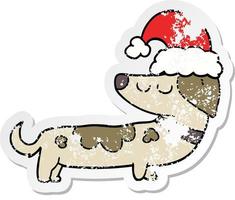 distressed sticker of a cartoon dog wearing christmas hat vector