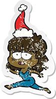 distressed sticker cartoon of a tired woman wearing santa hat vector