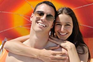 happy couple have fun on the beach photo