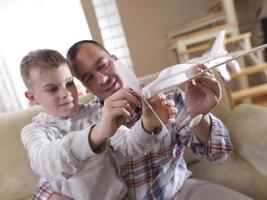 father and son assembling airplane toy photo