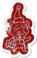 laughing teddy  bear with christmas present wearing santa hat vector