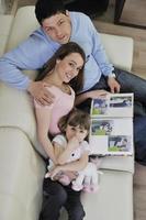 happy family looking photos at home