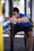 man doing pull ups on the vertical bar photo