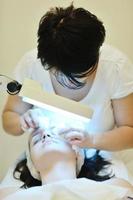 woman with facial mask in cosmetic studio photo