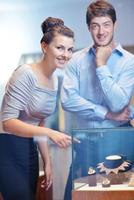 happy young couple in jewelry store photo