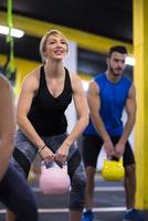 athletes doing exercises with kettlebells photo