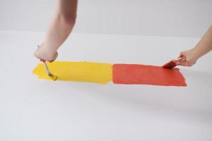 couple painting interior wall photo