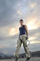 young man dancing and jumping  on top of the building photo