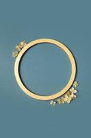 Golden ring and dried hydrangea flowers on a green background. Vertical format. Flat lay, top view, copy space photo