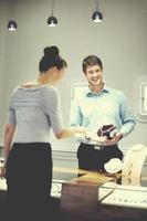 happy young couple in jewelry store photo