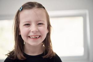 little girl without tooth smiling photo