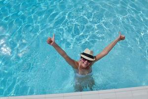 Happy woman in swimming pool photo