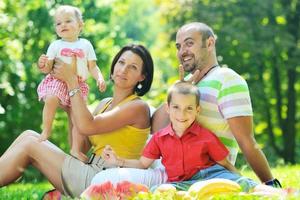 happy young couple with their children have fun at park photo