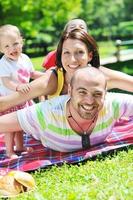 happy young couple with their children have fun at park photo