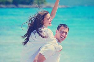 happy couple have fun on the beach photo