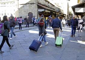 florencia, italia, 2019 - turistas cruzando el famoso puente ponte vecchio con sus tranvías en florencia, italia. foto