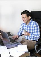 Man working from home with a laptop at the desk photo