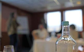 Selective focus on a water bottle during a business meeting photo