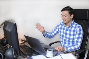 Man working from home with a laptop at the desk photo