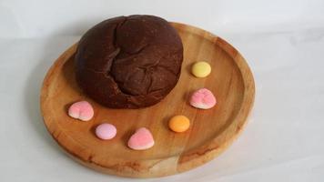 Dark brown bread and six cute candies photo