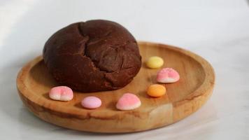 Dark brown bread and six cute candies photo