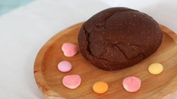 Dark brown bread and six cute candies photo