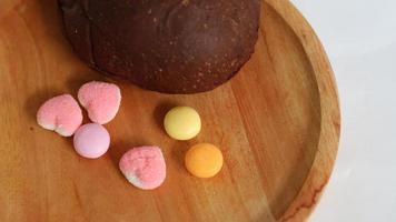 Dark brown bread and six cute candies photo