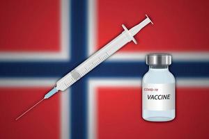 Syringe and vaccine vial on blur background with Norway flag
