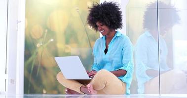black women using laptop computer on the floor photo