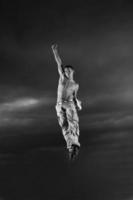 young man dancing and jumping  on top of the building photo